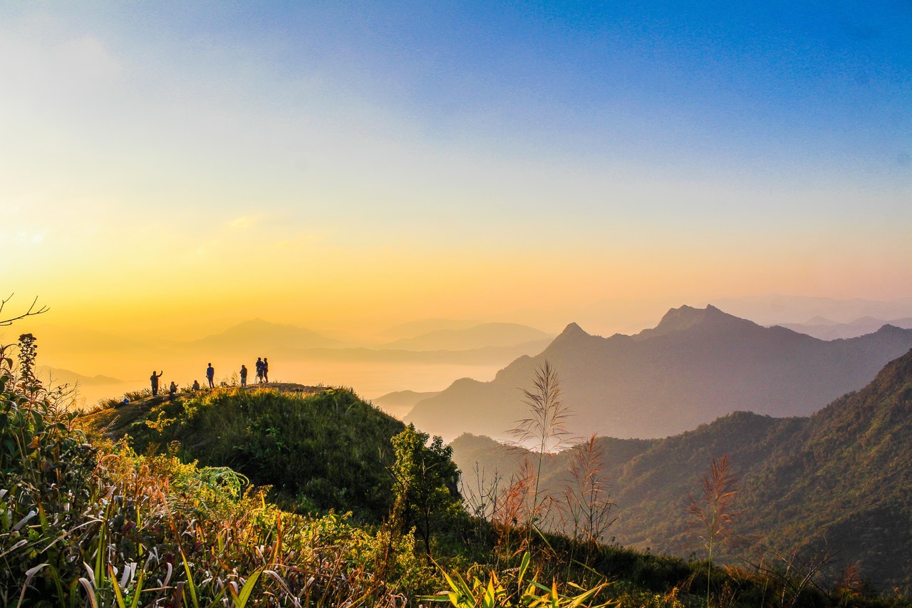 Photo Of People Standing On Top Of Mountain Near Grasses 733162